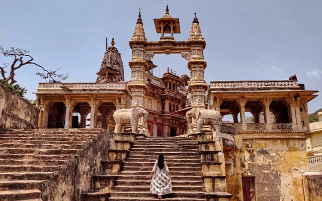 A woman posing in front of a temple in Jaipur