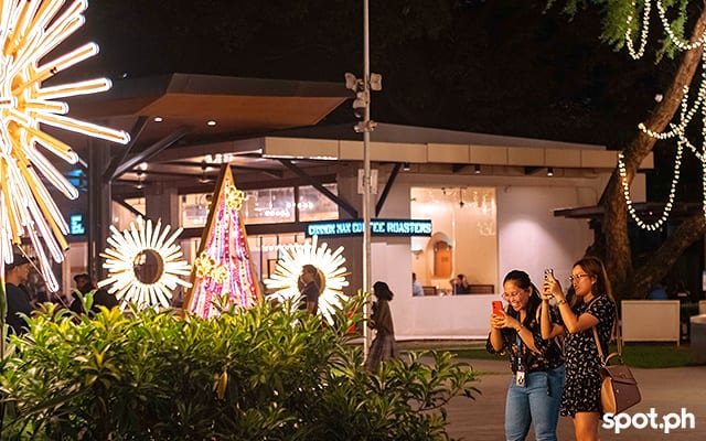People taking pictures at Ayala Triangle Gardens.