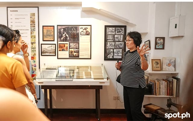 Behind Lorraine Sylianteng are photos and books about Evelyn Berg Empie,