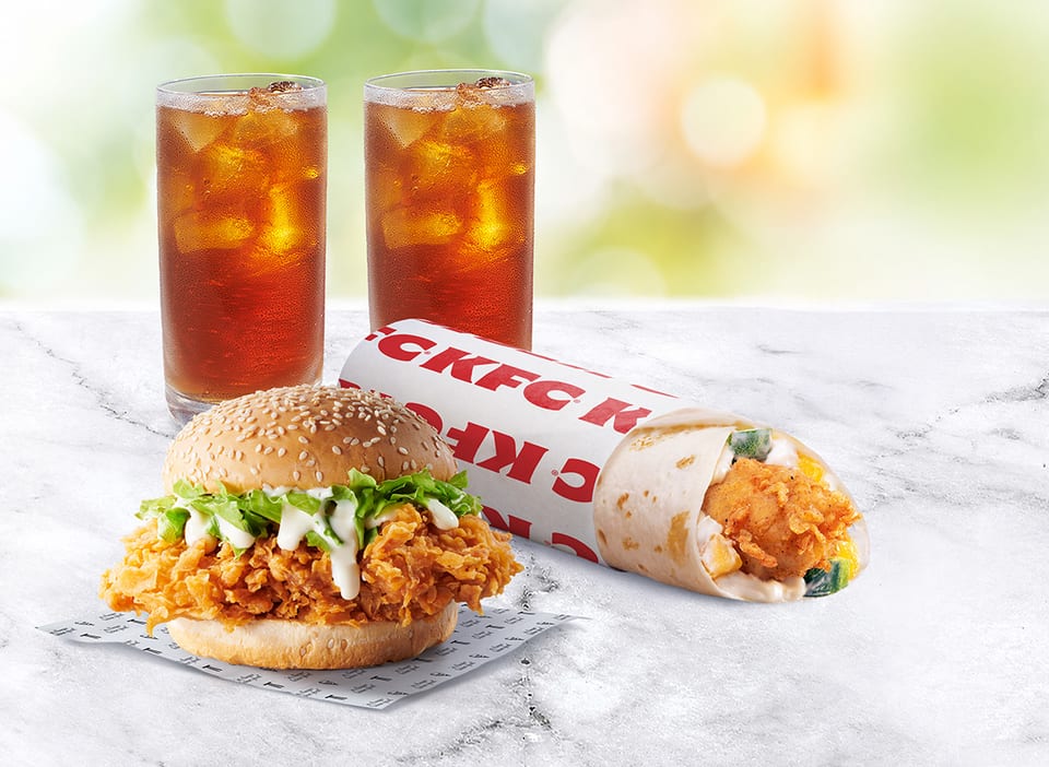 A photo of KFC's new Tenders Twister with the Zinger burger and iced tea